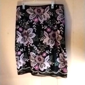 A black netted skirt w/pink embroidery flowers